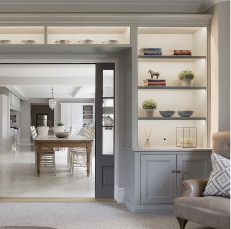 a living room filled with furniture and a large open door leading to a dining room