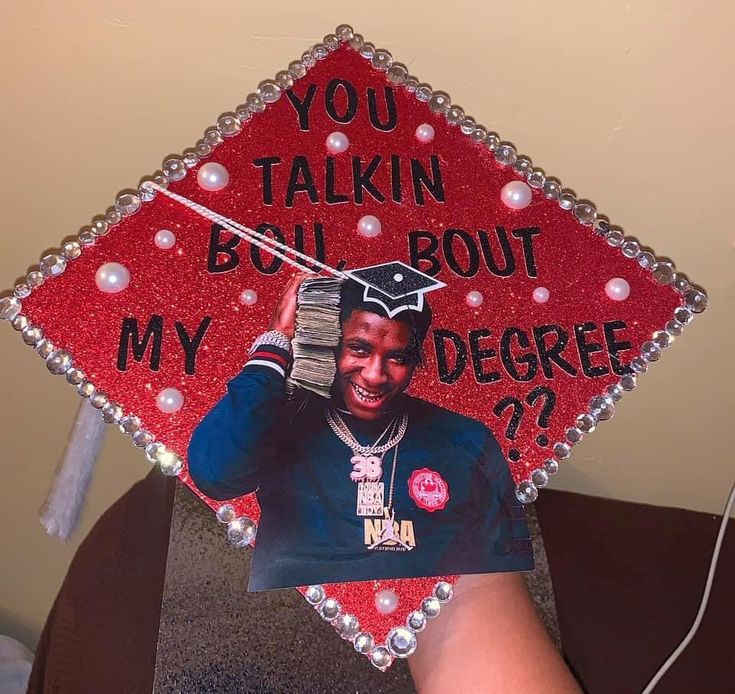 a red graduation cap with a picture of a man on it and the words, you talkin'bout bout my degree??