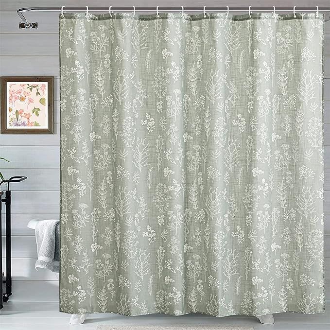 a bathroom with a shower curtain that has a flower pattern on it and a white toilet in the background