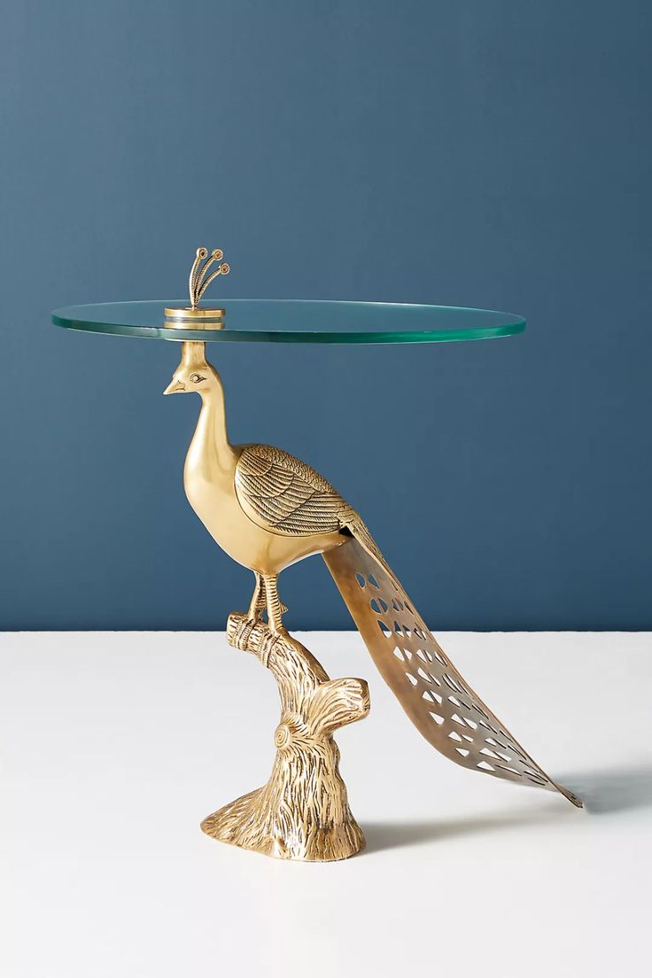 a glass table topped with a bird figurine