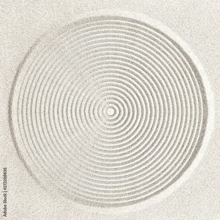 an image of a circular pattern in the sand with white sand on top and bottom