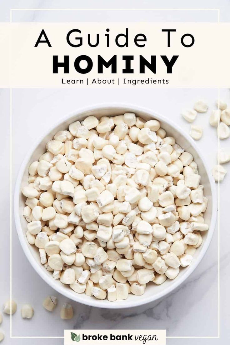 a bowl filled with white beans on top of a marble counter next to text that reads a guide to hominy learn about ingredients