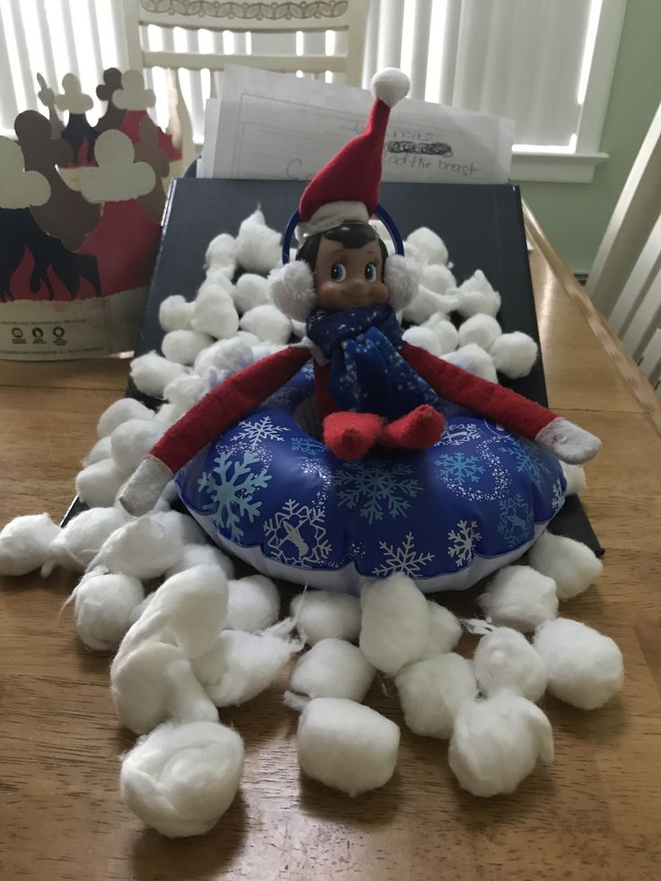 an elf sitting on top of a pile of cotton balls