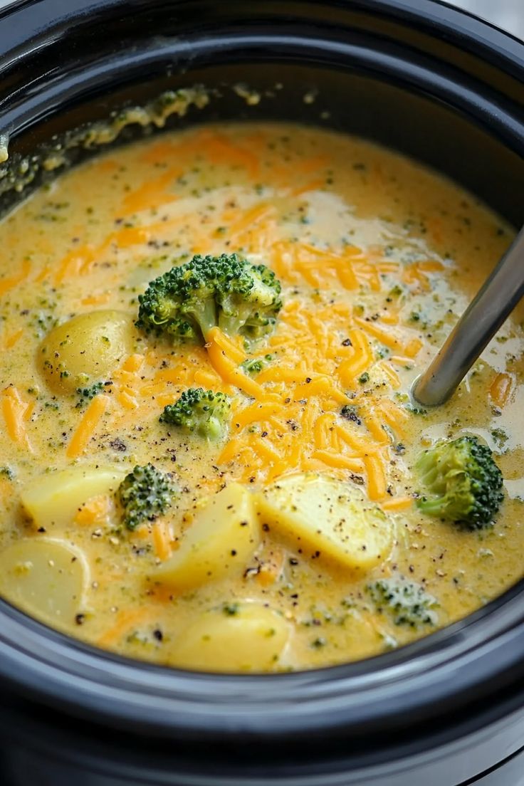 a crock pot filled with broccoli and cheese