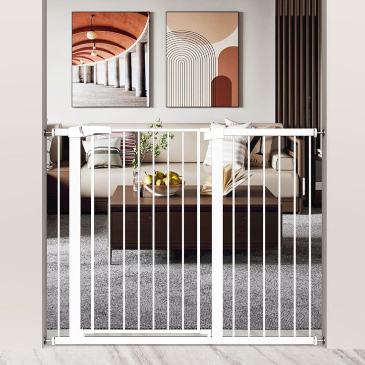 a living room with two pictures on the wall and a metal gate in front of it