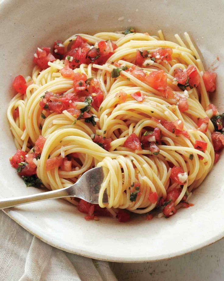 a white bowl filled with pasta and tomato sauce