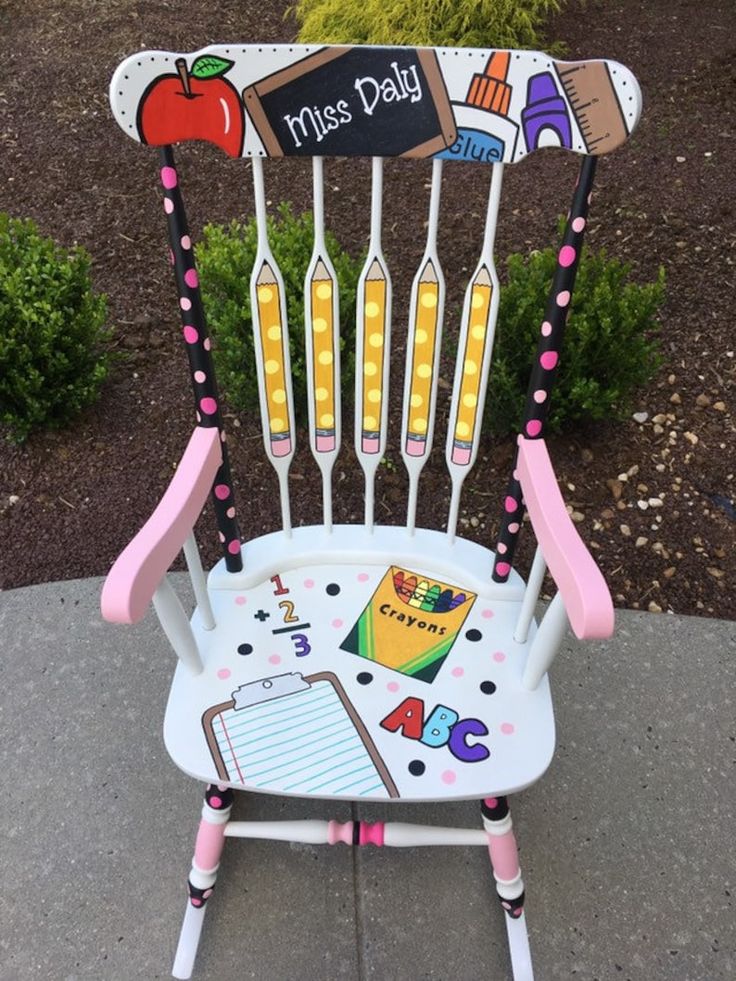 a child's rocking chair decorated with school supplies