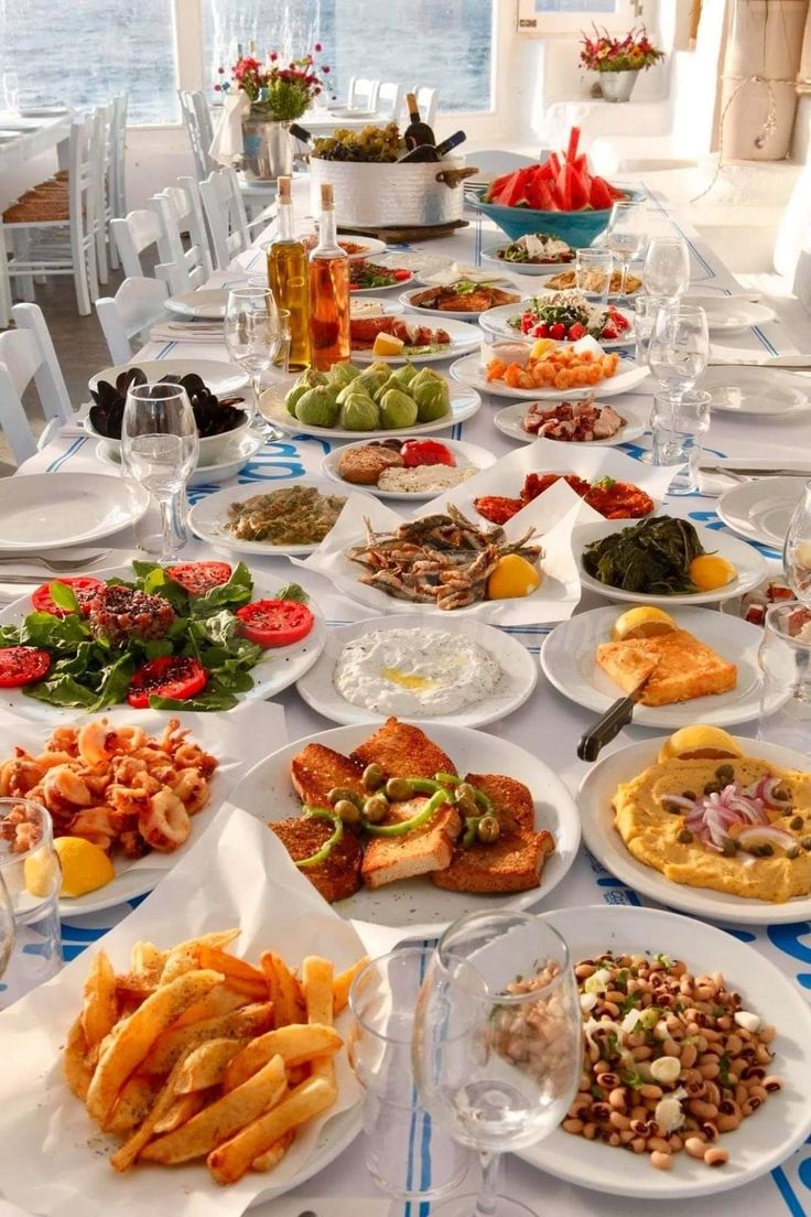 a long table filled with lots of plates and bowls full of food on top of it