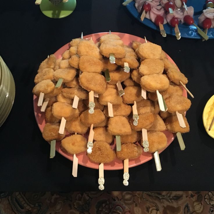 some food is sitting on a pink plate and there are other foods in the background