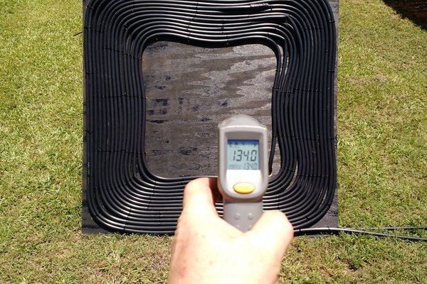 a hand is pointing at an outdoor heater