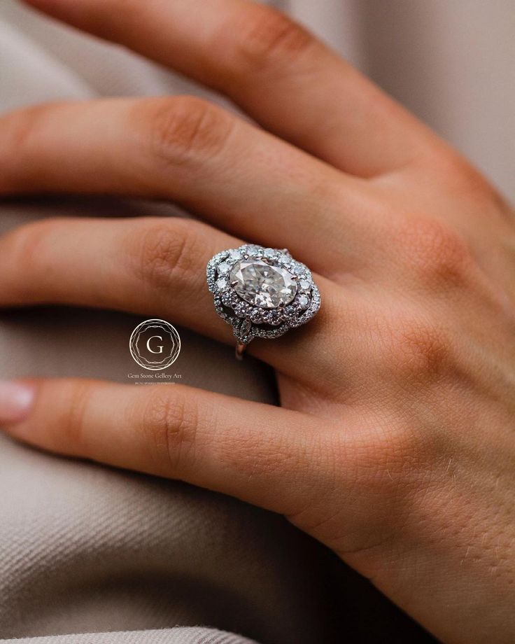 a woman's hand with an engagement ring on her finger