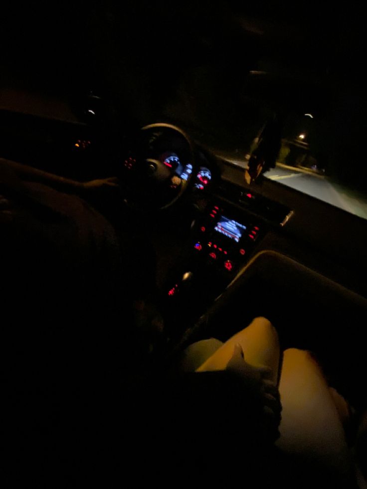 the interior of a car is lit up at night