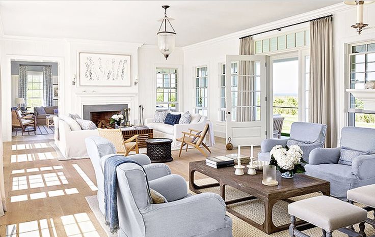 a living room filled with lots of furniture next to a fire place in a house