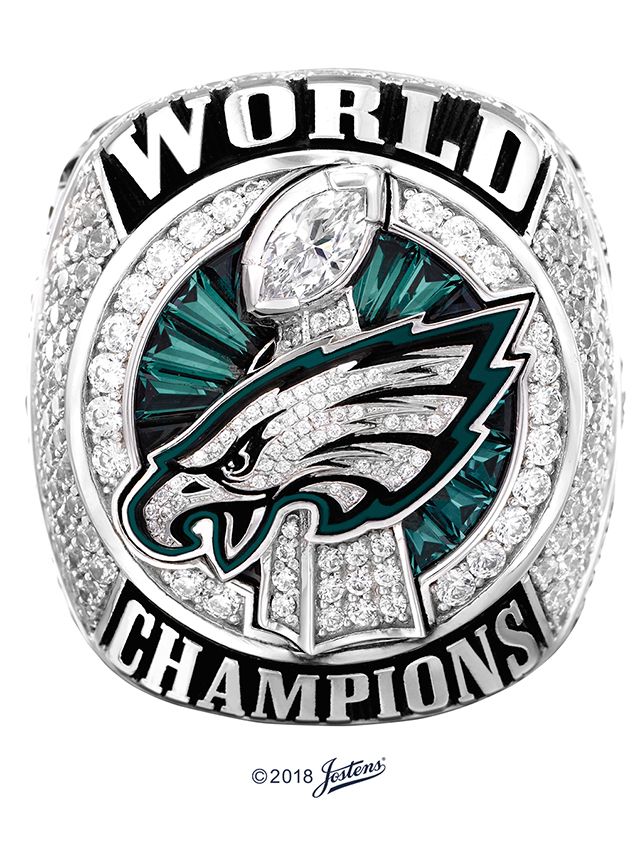 the philadelphia eagles ring is shown in white gold and green crystal stones, which are surrounded by words that read'world champs '