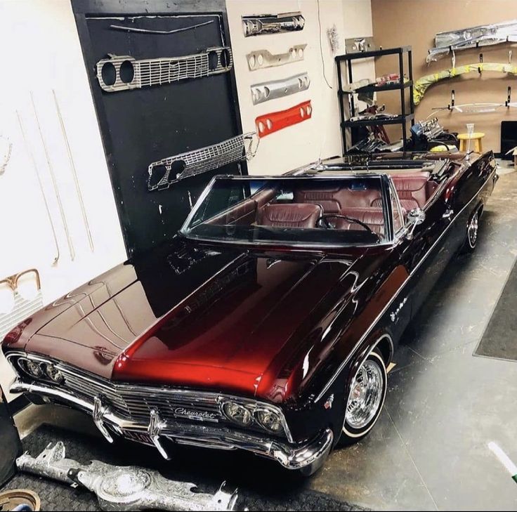 an old car is parked in a garage