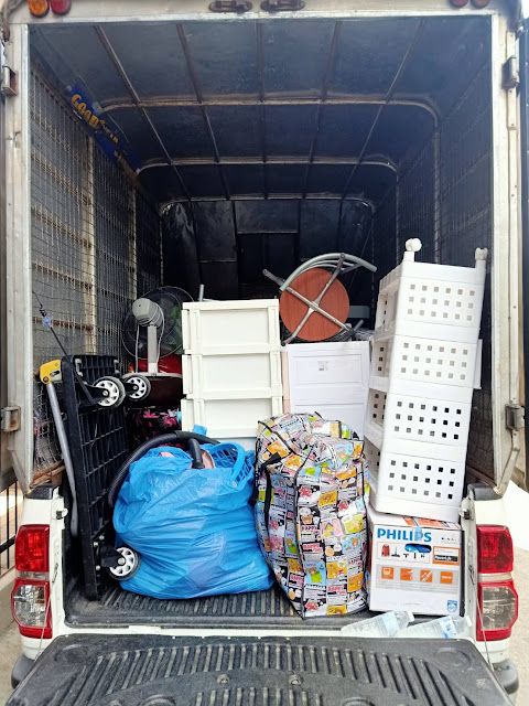 the back of a moving truck filled with items