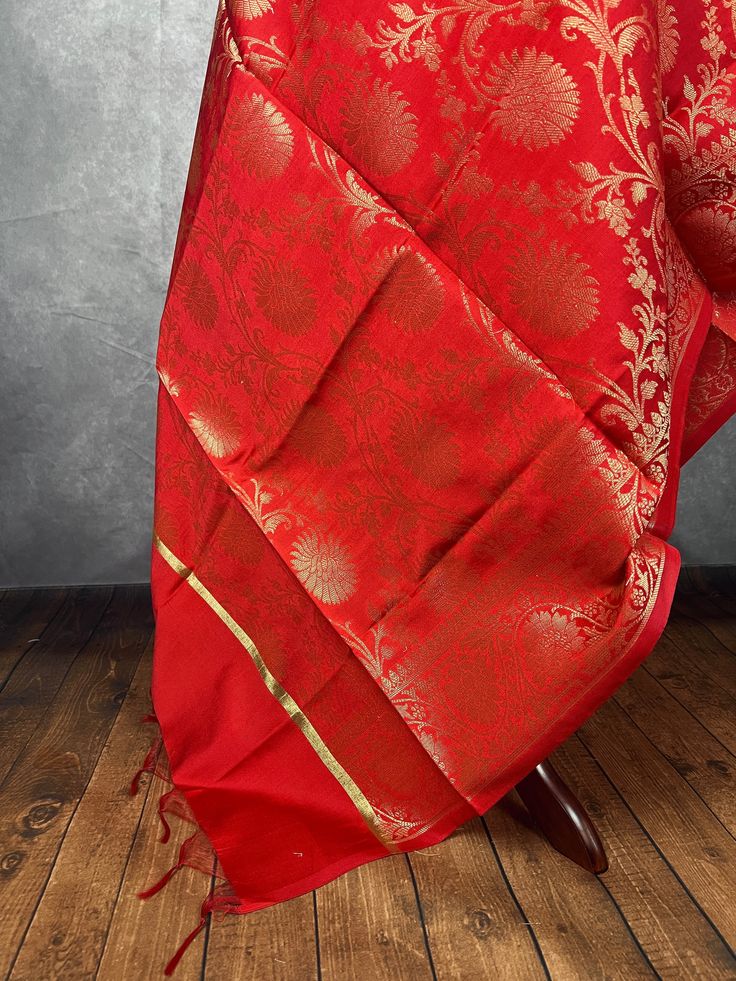 Beautiful Red Color Floral dupatta with muted gold Zari Weaving Work with red tassels. Dupatta has floral Jaal all over. Item: DupattaBase color : Red with Muted Gold Fabric : Soft Silk (Not Pure Silk)Work : Zari Weaved with tasselsLength of the Dupatta : 92 inches approx.Width of the dupatta : 35 1/2 inches (Approx.)Store Policies- No return or exchange will be accepted for color variations. Colors can vary in room light, sunlight and due to screen resolution and other reasons. - No return or e Gold Fabric, Scarf Gift, Room Lights, Pure Silk, Messenger Bag, Color Variations, Floral Pattern, Satchel, Weaving