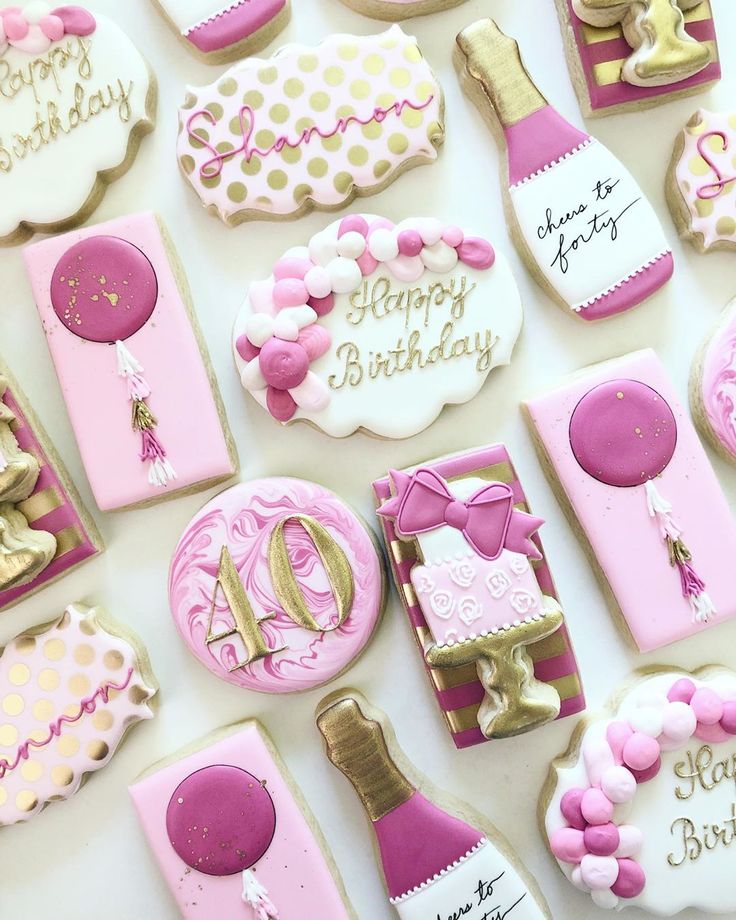 pink and gold decorated cookies with happy birthday written on the top, along with champagne bottles