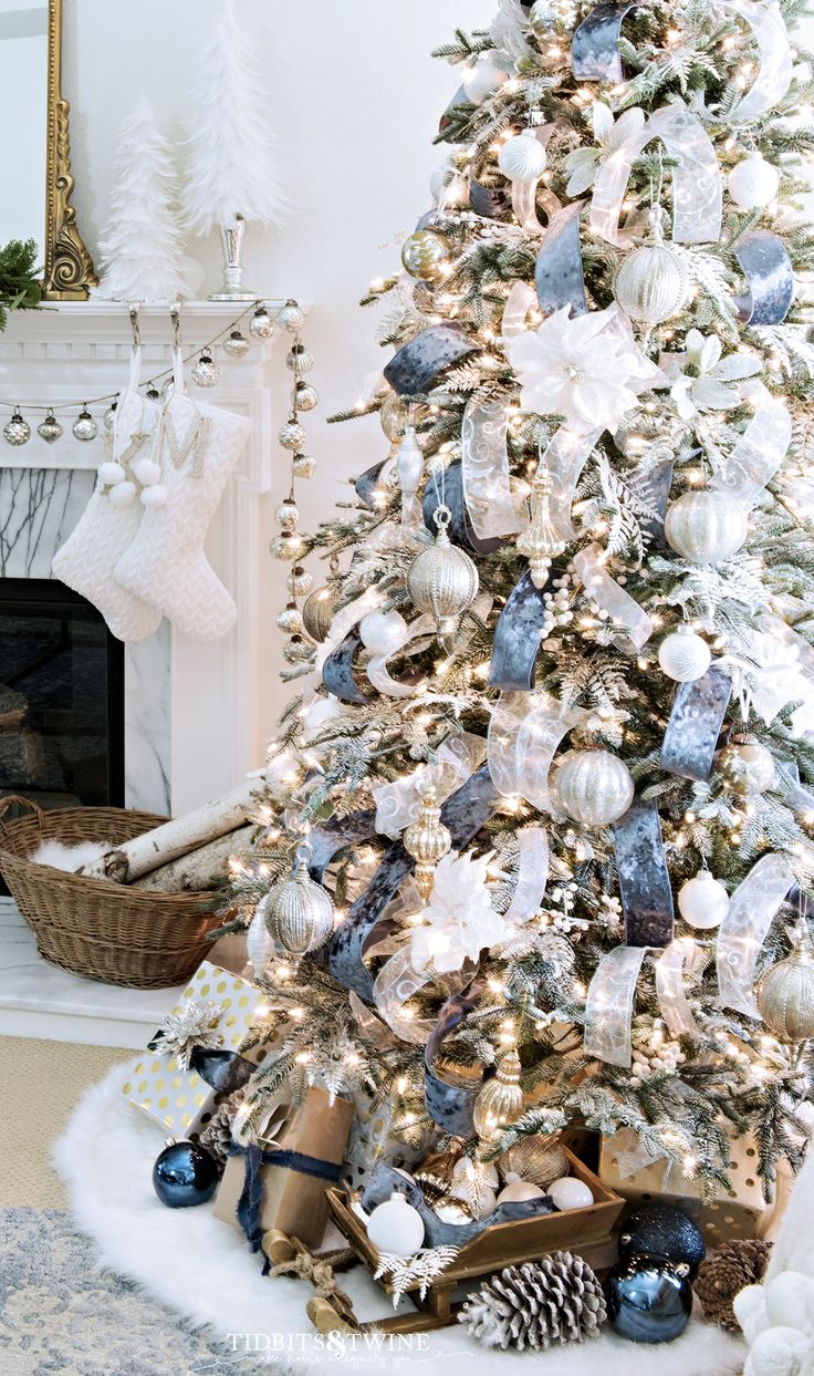 a white christmas tree with blue and silver ornaments