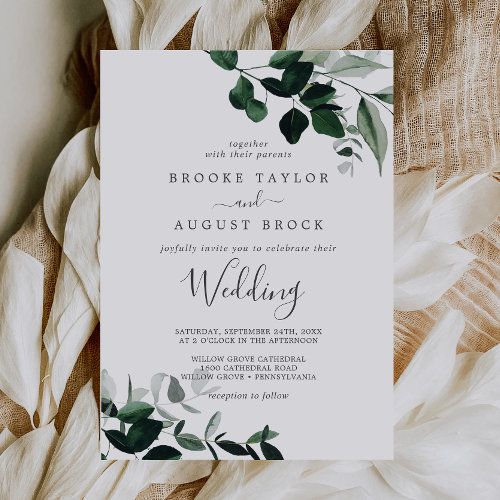 a wedding card with greenery on it