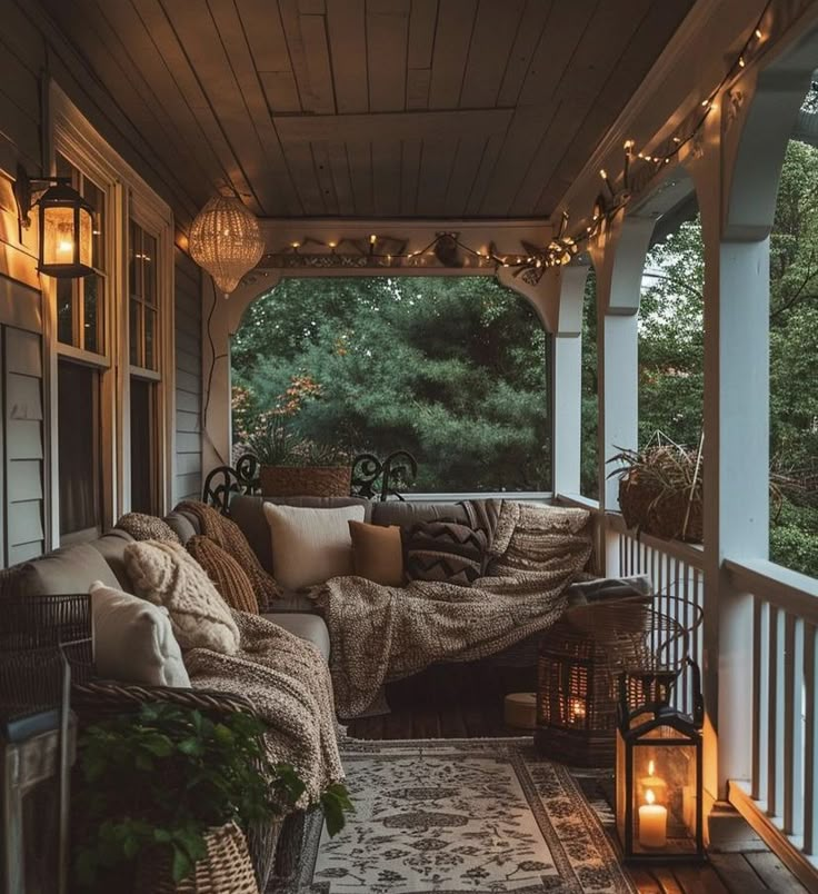 a porch with lights and pillows on it