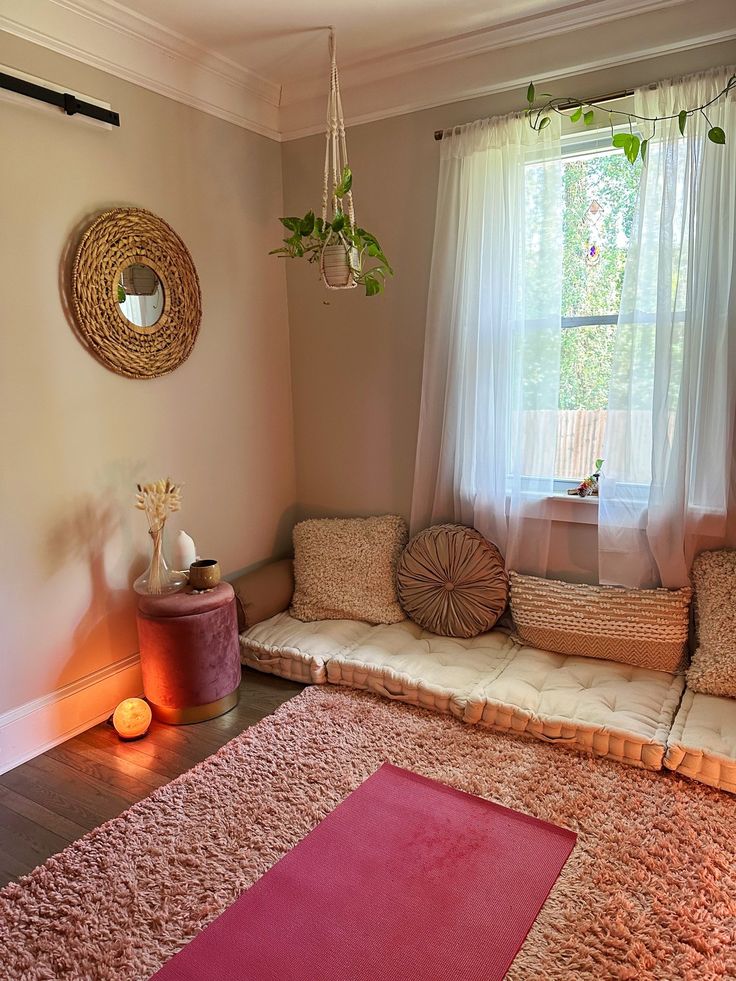 a living room filled with furniture and a pink rug