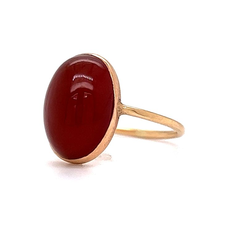 This stylish Victorian Bezel Set Carnelian Cocktail Ring features a cabochon cut red carnelian in polished 14 karat yellow gold. The center gemstone showcases a warm, crimson red hue. Set in a bezel on a dainty band. Perfect for signet ring & statement ring lovers. Timeless and chic. This antique cocktail ring would make a great gift for any loved one! Classic Red Ruby Ring With Oval Cabochon, Classic Red Ruby Ring, Oval Cabochon, Classic Red Bezel Set Ring, Classic Red Rings With Bezel Setting, Classic Red Ring With Bezel Setting, 14k Gold Red Cabochon Ruby Ring, Red Cabochon Ruby Ring In 14k Gold, Red Polished Carnelian Rings, Red Ruby Oval Cabochon Ring In 14k Gold