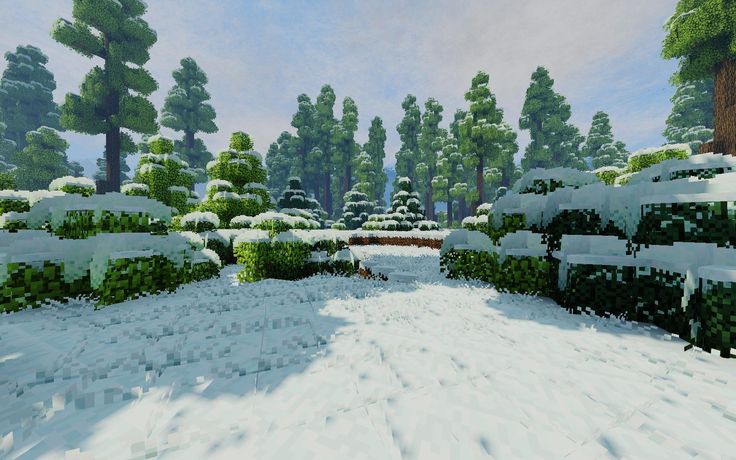 a snow covered park with benches and trees