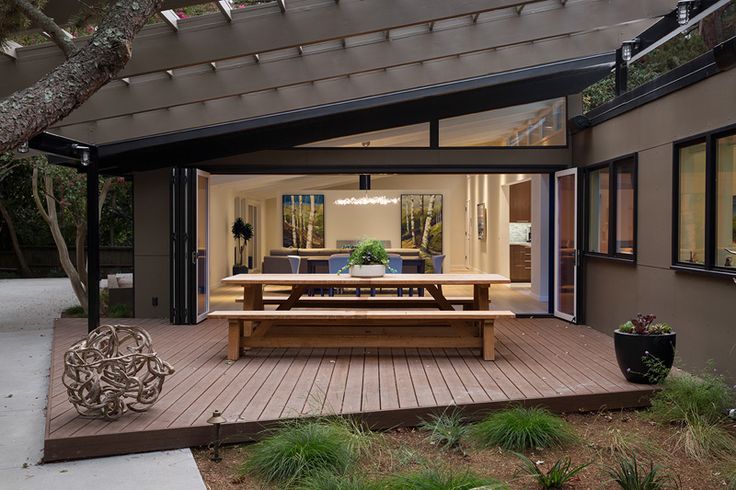 an image of a screen shot of a backyard with a picnic table and bench in the foreground