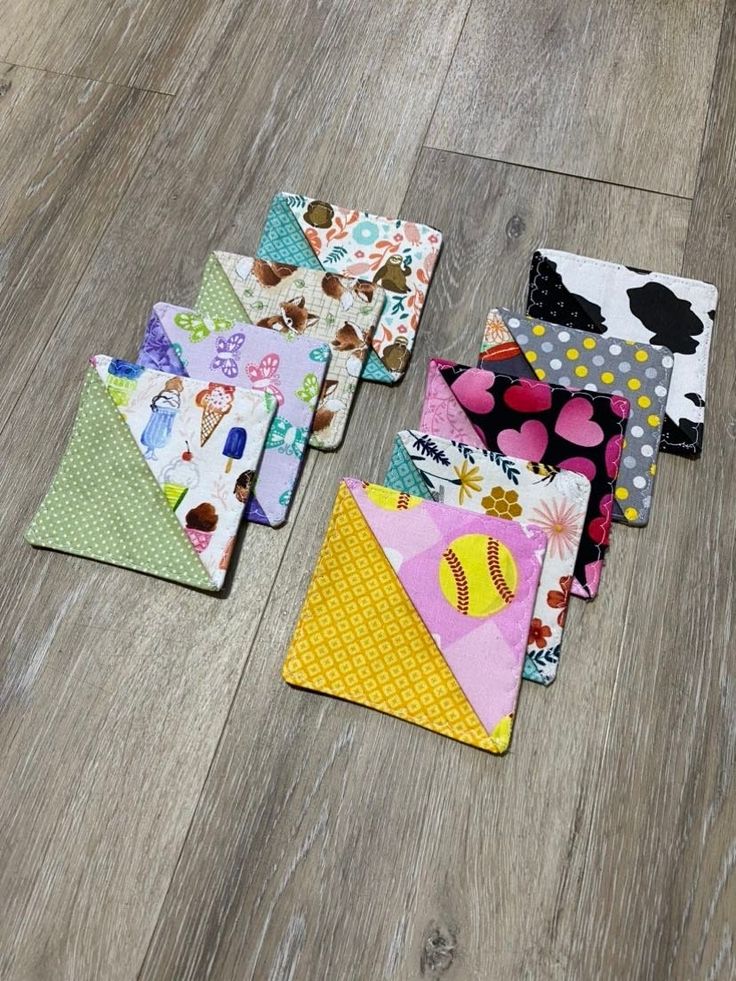 several pieces of fabric laid out on the floor next to each other with different designs