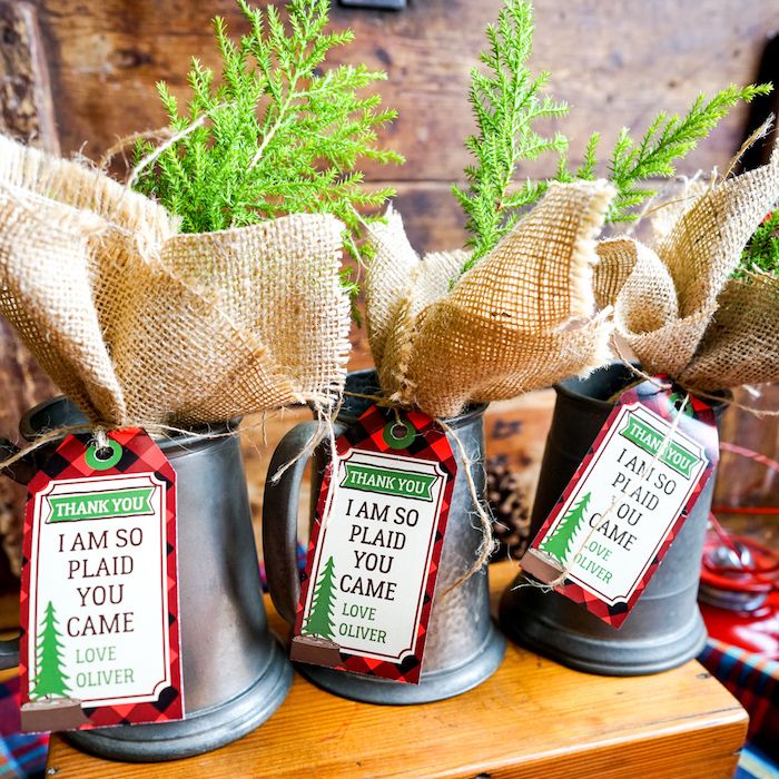 three metal mugs with christmas tags on them