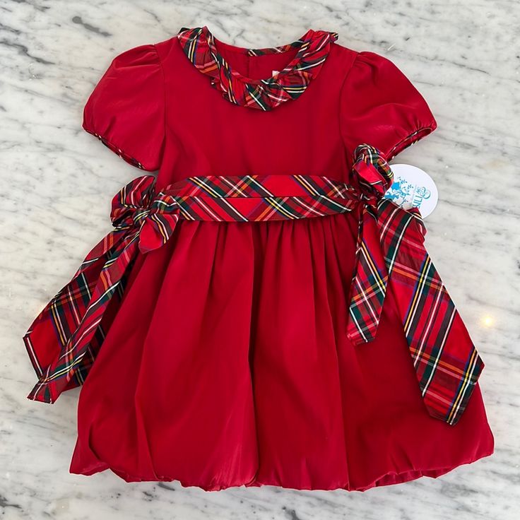 New Girls Luli & Me Party Dress. Its A Vibrant Red With Holiday Plaid Trim Sash That Ties On Either Side Of The Waist. The Bubble Style Hem Makes For A Very Full Skirt. There Is A Ruffle Of Plaid Around The Neck. It Buttons Up The Back Of The Bodice. There Is A Big Sister Dress Listed Separately. All Of My Items Are Brand New With All Tags Attached From The Manufacturer. Please Feel Free To Ask Any Questions Dupioni Silk Dress, Girl Silk Dress, Dark Green Velvet Dress, Pink Bow Dress, Raw Silk Dress, 2025 Christmas, Smocked Bishop Dress, Plaid Party