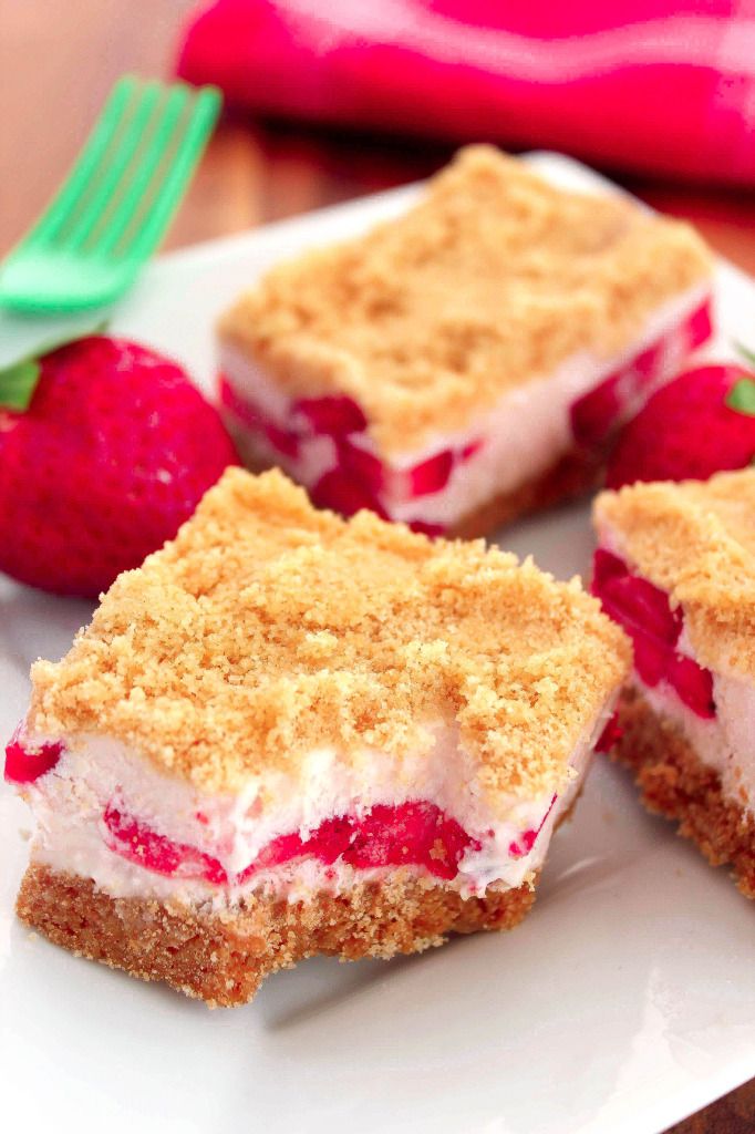 three pieces of cake on a plate with strawberries