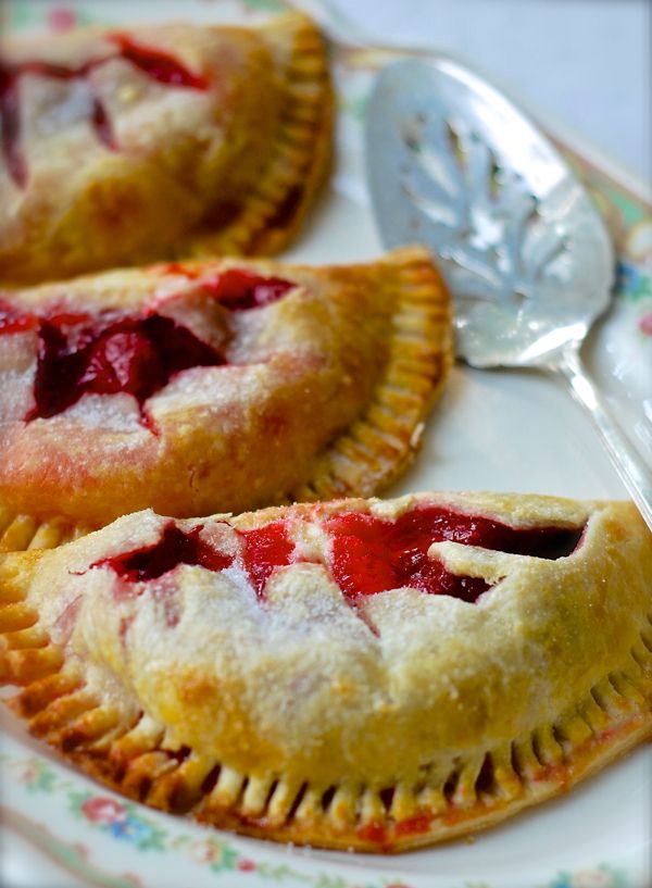 three pastries on a plate with spoons