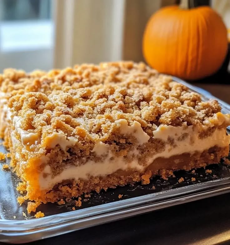 a piece of cake sitting on top of a metal pan next to a pumpkin tree