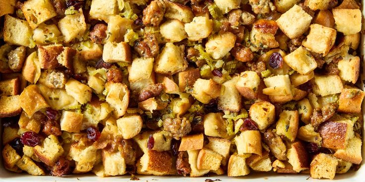 a casserole dish with stuffing and cranberries in it, ready to be eaten