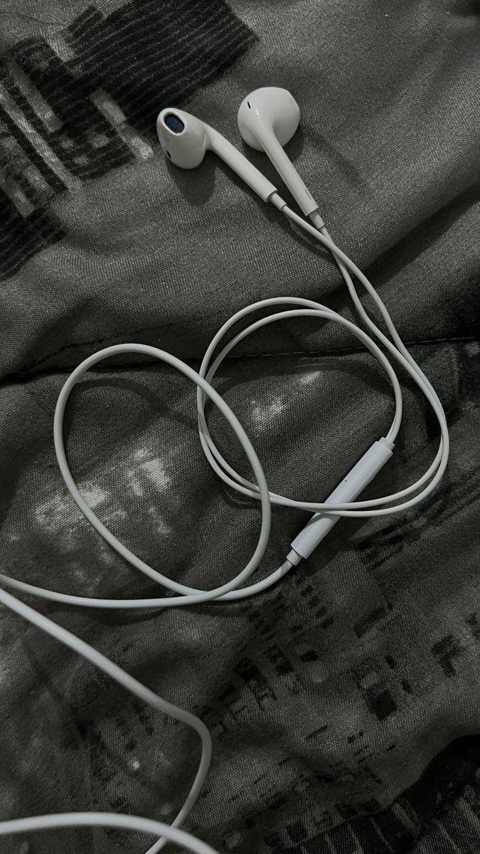 two earphones laying on top of a blanket