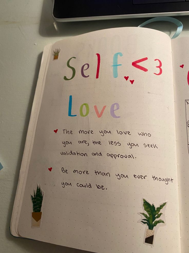 an open notebook with writing on it and a computer keyboard in the background, along with a handwritten note about self love