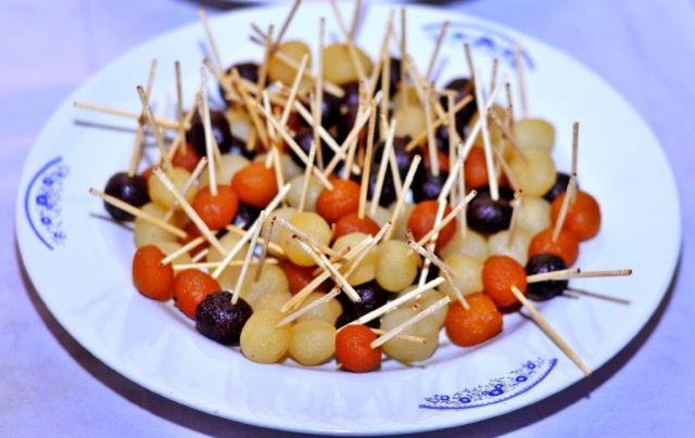 a white plate topped with lots of food on top of a table