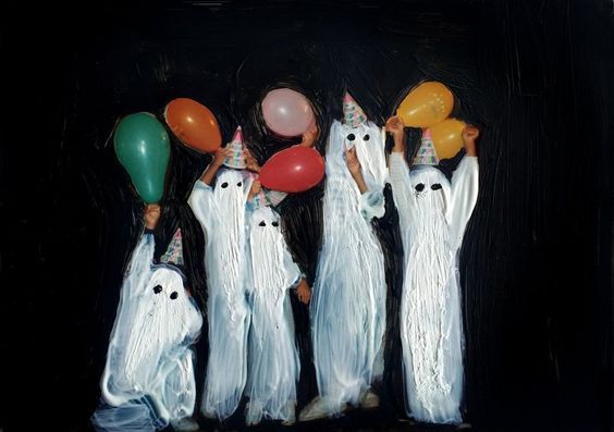 three ghost figures holding balloons in their hands