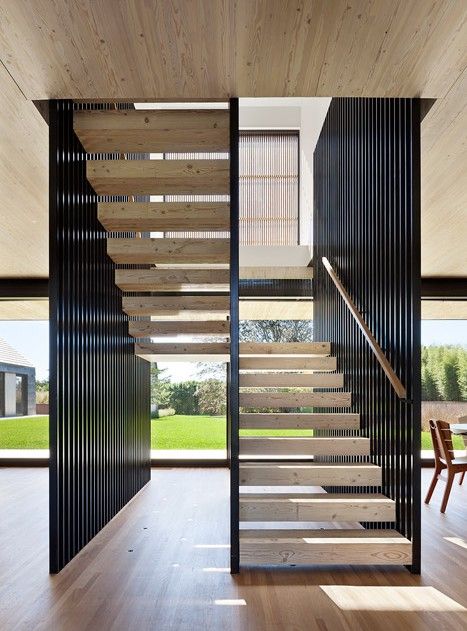 the stairs are made out of wood and have black slats on each one side