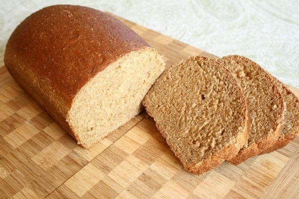 a loaf of bread sitting on top of a wooden cutting board