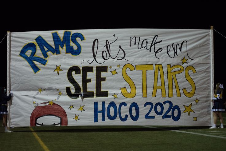 a banner that reads rams make our see stars hoco 2020 on it and some cheerleaders standing behind it