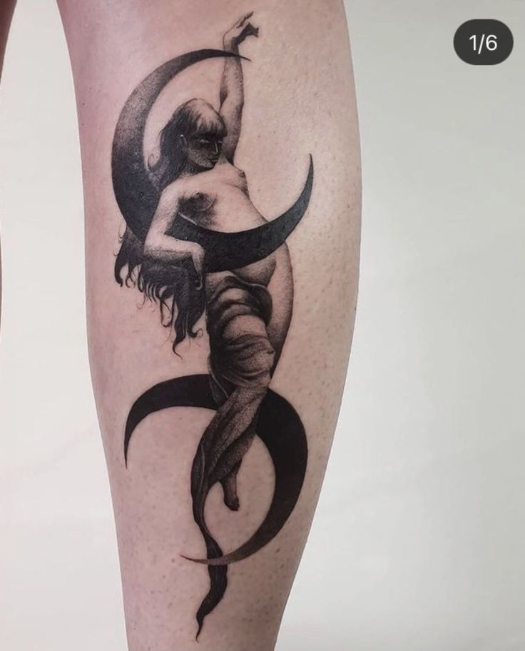 a woman's leg with a tattoo on it that has an image of a person holding