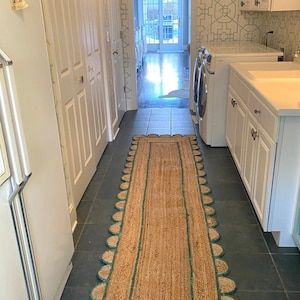 a kitchen with a rug on the floor