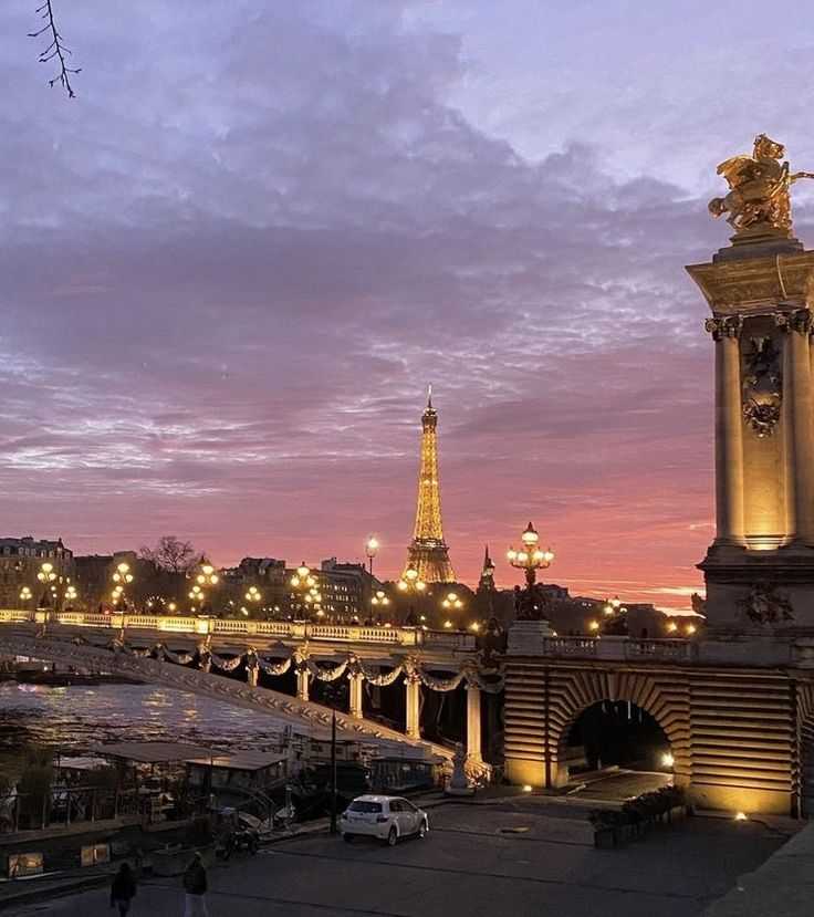 the eiffel tower is lit up at night