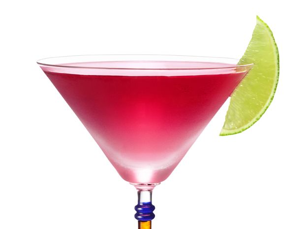 a pink martini with a lime wedge on the rim