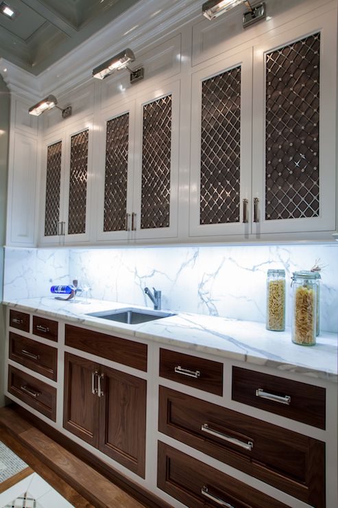 a kitchen with marble counter tops and wooden cabinets