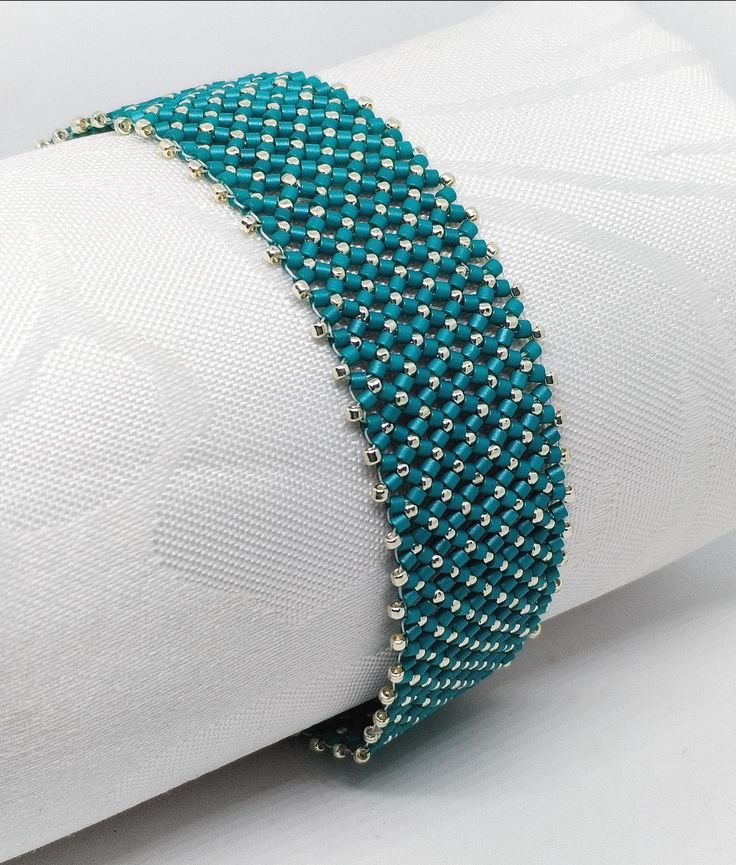 Teal- silver beacelet  Sometimes a simple but quite recorativevbracelet is required. This is such a beacelet!  The smoothness of the flat chenille stitch gives this bracelet an extra chick. I created this 18 cms long, IT closee with a slide ín magnetic clasp. The jewellery will be posted from Hungary via postal services. If you have any further questions, do not hesitate to contact me. Elegant Turquoise Bracelets With Silver Beads, Elegant Handmade Silver Friendship Bracelet, Silver Beaded Bracelets With Round Beads, Silver Tiny Beads Bracelet For Party, Silver Bracelets With Tiny Beads For Party, Silver Bracelet With Tiny Beads For Party, Silver Bangle Bracelets With Tiny Beads, Silver Bangle Bracelet With Tiny Beads, Silver Bead Bracelet