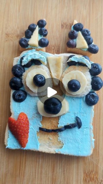 a cake made to look like a face with blueberries on it